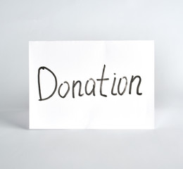 inscription donation  black marker on a white sheet of paper