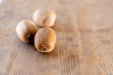fresh kiwi on wooden table. copy space.