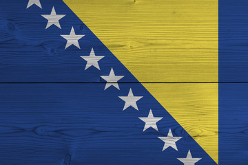 Bosnia and Herzegovina flag painted on old wood plank