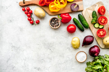 Vegan food cooking with raw vegetables on white stone background top view mock up