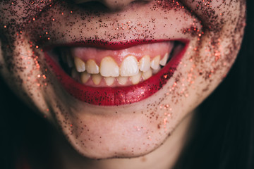 Fototapeta premium Close-up of woman's lips with fashion bright red make-up. Beautiful female mouth, full lips with perfect makeup. Part of female face. Choice lipstick. 