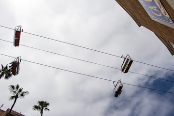 Sky Ride Silhouette with the Palm Trees and Cloudy Sky in the Background at the San Diego County Fair, California, USA