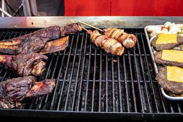 Barbecue Ribs, Bacon Pops, and Cheeseburgers Grilling at a Food Stall at the San Diego County Fair, California, USA