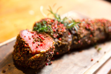 Raw beef marinated in spices. Fresh beefsteak in marinade of pepper and herbs