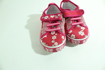 Baby pink shoes with flowers.