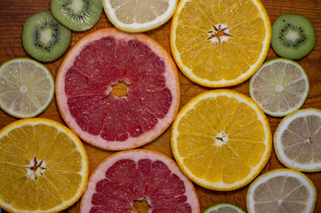 Fototapeta na wymiar Citrus fruit slices on table