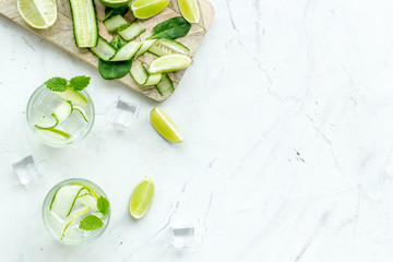 healthy drinks with lime and ice for summer on white background top view mock up