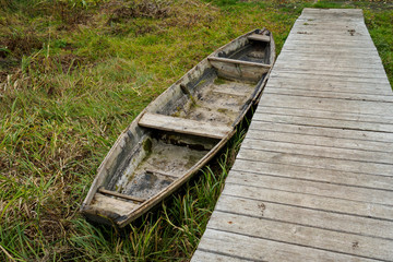 old broken boat at the wooden floor