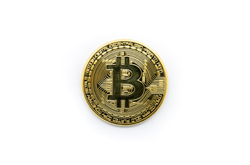 Physical gold Bitcoin isolated against a white background