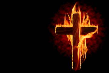 Cross burning or lighting concept theme with wooden crucifix engulfed in fiery flames isolated on...