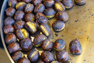 Roasted chestnuts in a blue pan for sale in the street in Kyoto