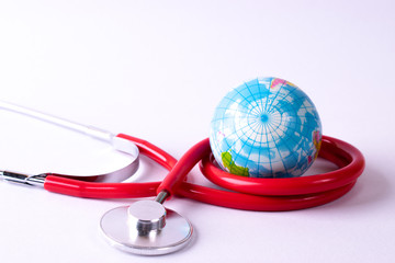 World health day, Healthcare and medical concept. Stethoscope wrapped around globe on white background.