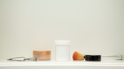 Pill bottle and makeup in medicine cabinet