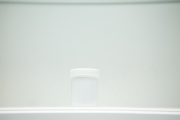 White pill bottle in white cabinet