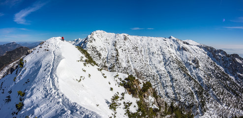 Panoramic photo of the winter mountain ridge with Baseljski vrh and Mali Grintavec in Kamnik-Savinja Alps