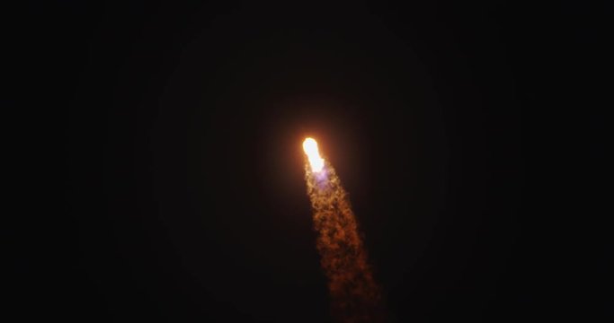 Rocket flying into dark night sky with flames and fire from the engines.  Includes audio.