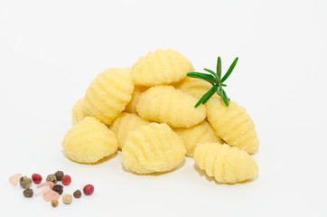 Uncooked fresh homemade gnocchi isolated on white background. Italian cuisine - raw gnocchi, made of potato, flour and egg on white.     
