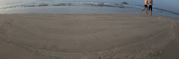 People running on the beach.