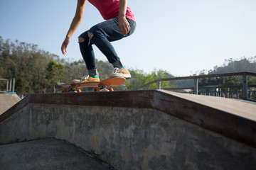 Skateboarder skateboarding at skatepark ramp
