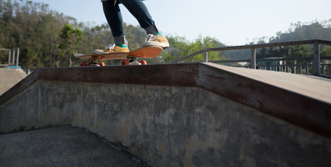 Fototapeta na wymiar Skateboarder skateboarding at skatepark ramp