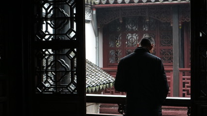 Introspective man deep in thought looks over a balcony