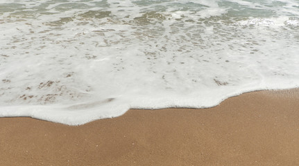 Soft wave of the sea on the sand beach.