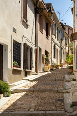 Narrow cobblestone street opposite the Arles amphitheatre, France