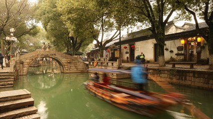 Fototapeta na wymiar Boat moving along an ancient Chinese canal