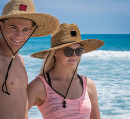 couple on a beach looking at surf 2