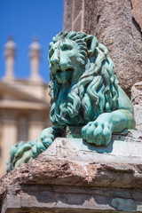 Bronze lions on the 'Needle of Arles' obelisk in the main square in Arles, France