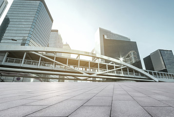 empty brick floor and cityscape of modern city near