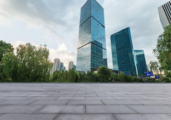 Fototapeta premium empty brick floor and cityscape of modern city near