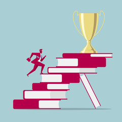 Businessman runs to the trophy from books. Isolated on blue background.