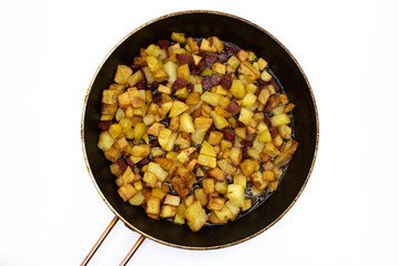 sucuk (sujuk) and french fries. potatoes and sucuk (sujuk) in frying pan. Turkish homemade french fries. Sujuk (sucuk) isolated on white background