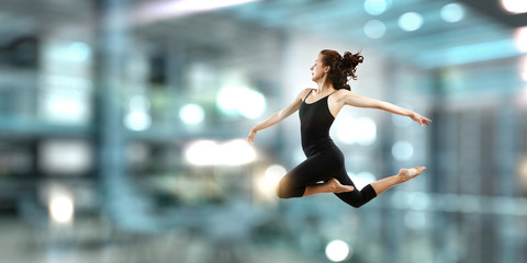 Fototapeta premium Gymnast girl in jump Mixed media