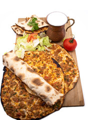 Turkish pizza, lahmacun, isolated on white background. lahmacun on a wooden table. Horizontal. one rolled with fresh garnish on the white surface.Cold buttermilk (ayran) near it.Close up taken,isolate