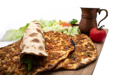 Turkish pizza, lahmacun, isolated on white background. lahmacun on a wooden table. Horizontal. one rolled with fresh garnish on the white surface.Cold buttermilk (ayran) near it.Close up taken,isolate