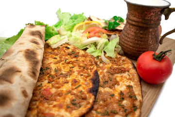 Turkish pizza, lahmacun, isolated on white background. lahmacun on a wooden table. Horizontal. one rolled with fresh garnish on the white surface.Cold buttermilk (ayran) near it.Close up taken,isolate