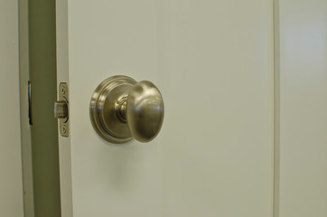 A open door in the store with a new nickel plated handle on display. 