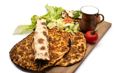 Turkish pizza, lahmacun, isolated on white background. lahmacun on a wooden table. Horizontal. one rolled with fresh garnish on the white surface.Cold buttermilk (ayran) near it.Close up taken,isolate