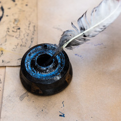 Black inkpot and a quill