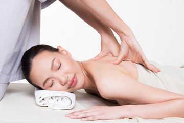 Obraz na płótnie Canvas Body Massage on specific naked back of Asian woman by pressing fingers on pain or stress muscle point to release relax. Therapist Spa body massage woman hands treatment on customer, isolated on white