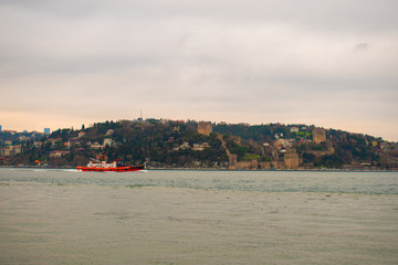 Fototapeta na wymiar ships passing through the Bosphorus. ships passing under the Bosphorus and Fatih Sultan Mehmet Bridge.