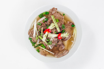 Traditional oriental cuisine of  Vietnam. Pho bo soup with rice noodles, beef, pepper, wheat germ, greens