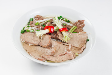 Traditional oriental cuisine of  Vietnam. Pho bo soup with rice noodles, beef, pepper, wheat germ, greens