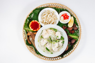 Traditional oriental cuisine of  Vietnam. Soup pho ga with rice noodles, chicken, pepper, wheat germ, greens