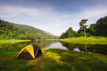 Camping tent for relaxing along the reservoir with surrounding mountain