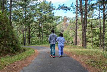 Fototapeta premium Happy couple walking in the pine forest