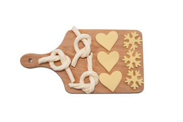 cheese slices on cutting board. bow, snowflake heart shaped cut cheese