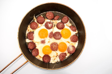 Turkish Sausage (sucuk) and egg. Turkish sausage and egg in pan on white background